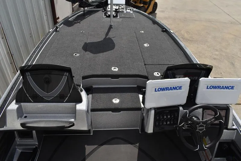 Slide: The Image of 2025 Triton 21XP Patriot boat interior with dual Lowrance displays and spacious deck. - 16