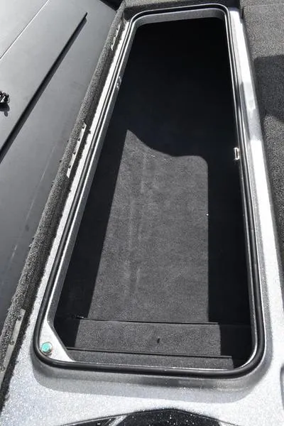 Slide: The Image of Open storage compartment in 2025 Triton 21XP Patriot boat. - 17