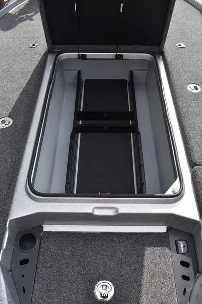 Slide: The Image of Open storage compartment on 2025 Triton 21XP Patriot boat. - 18