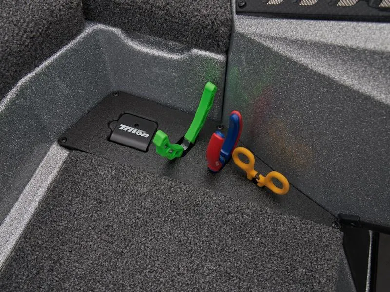 Slide: The Image of Interior of 2025 Triton 21XP Patriot boat with colorful tools on carpeted floor. - 23