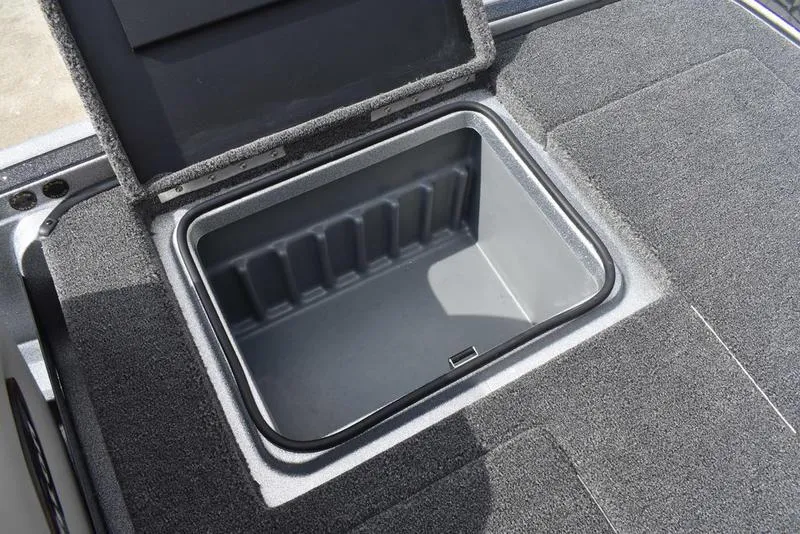 Slide: The Image of Open storage compartment in 2025 Triton 21XP Patriot boat. - 34