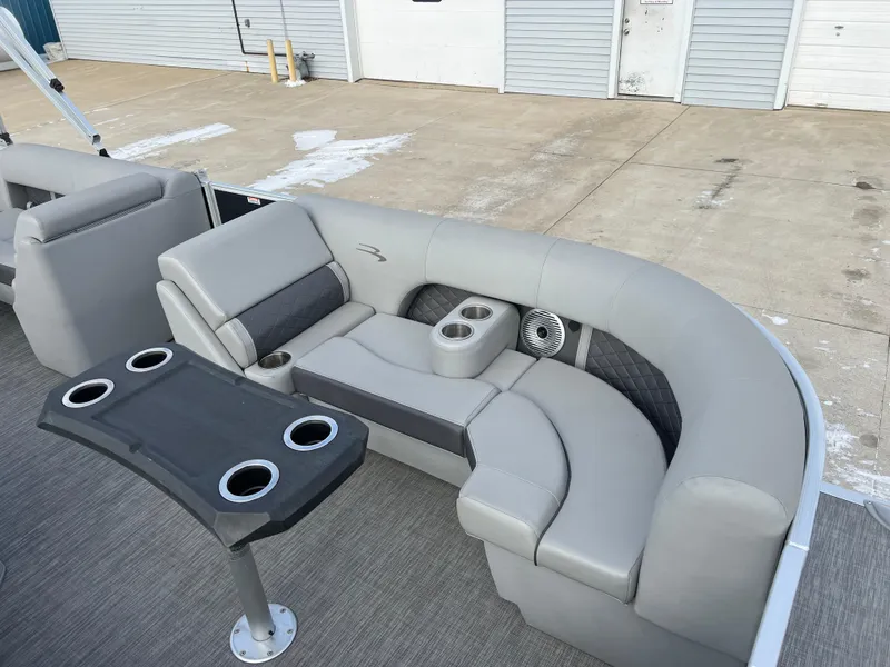 Slide: The Image of 2021 Bennington L 21 Swingback pontoon boat with gray seating and cup holders. - 12