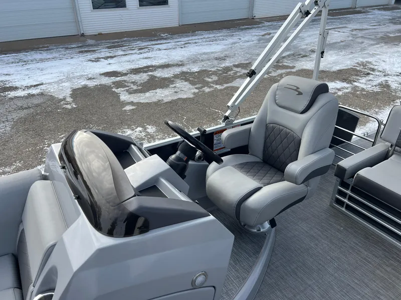 Slide: The Image of 2021 Bennington L 21 Swingback boat interior with steering wheel and seating. - 16