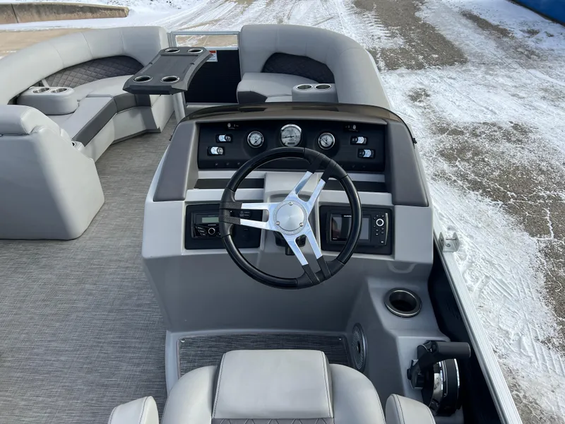 Slide: The Image of 2021 Bennington L 21 Swingback boat interior with steering wheel and seating. - 17