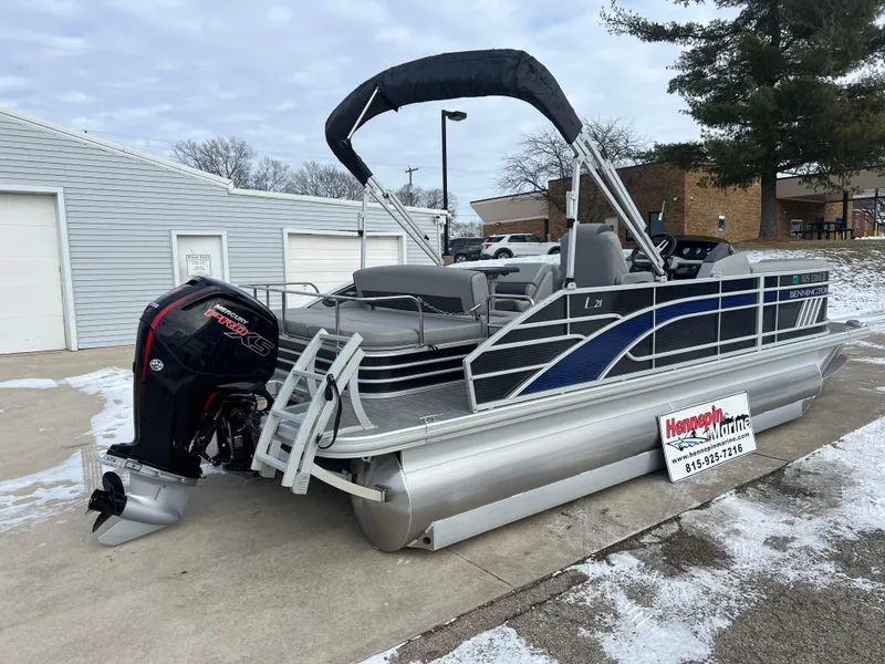 Slide: The Image of 2021 Bennington L 21 Swingback pontoon boat with outboard motor on snowy driveway. - 7