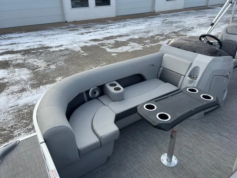 Slide: The Image of 2021 Bennington L 21 Swingback boat interior with gray seating and cup holders. - 9
