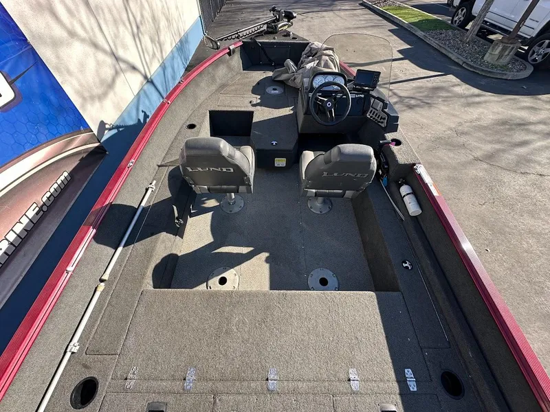 Slide: The Image of 2015 Lund 1750 Rebel XS SS fishing boat interior with seating and control console. - 11