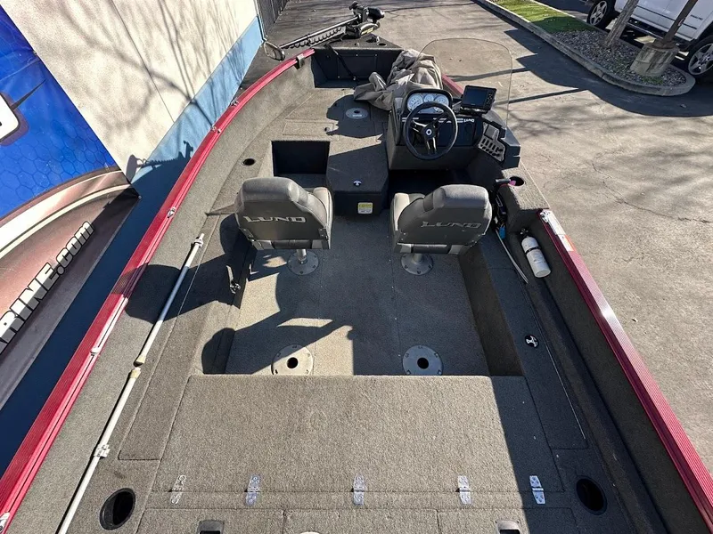 Slide: The Image of 2015 Lund 1750 Rebel XS SS boat interior with two seats and steering console. - 12
