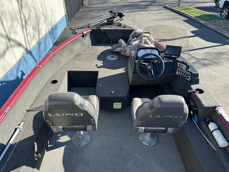 Slide: The Image of 2015 Lund 1750 Rebel XS SS boat interior with dual seats and steering console. - 13