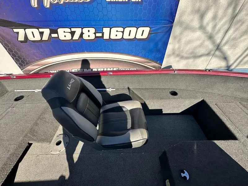 Slide: The Image of 2015 Lund 1750 Rebel XS SS boat interior with seating and storage compartments. - 14