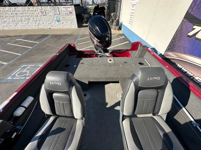 Slide: The Image of 2015 Lund 1750 Rebel XS SS boat interior with two seats and motor. - 15