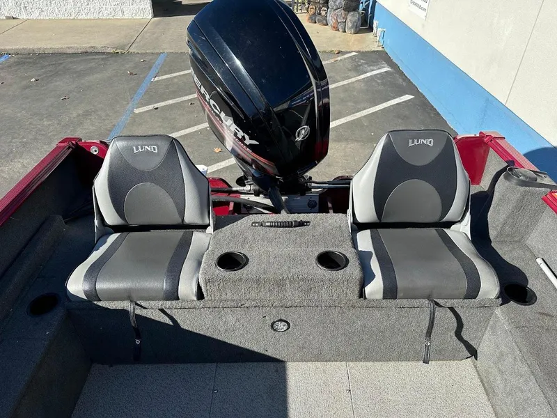 Slide: The Image of 2015 Lund 1750 Rebel XS SS boat interior with two seats and motor. - 17
