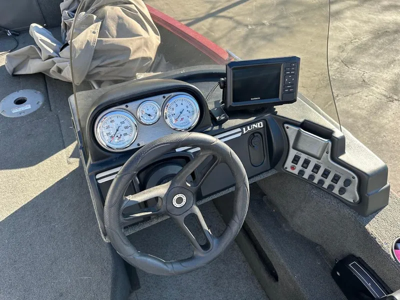 Slide: The Image of 2015 Lund 1750 Rebel XS SS boat dashboard with steering wheel and gauges. - 20