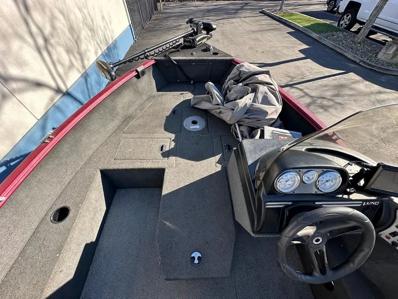 Slide: The Image of 2015 Lund 1750 Rebel XS SS boat interior with steering wheel and gauges. - 24