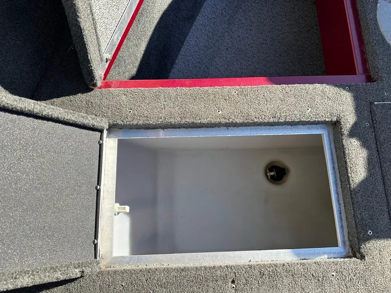 Slide: The Image of 2015 Lund 1750 Rebel XS SS boat storage compartment, open and empty. - 28