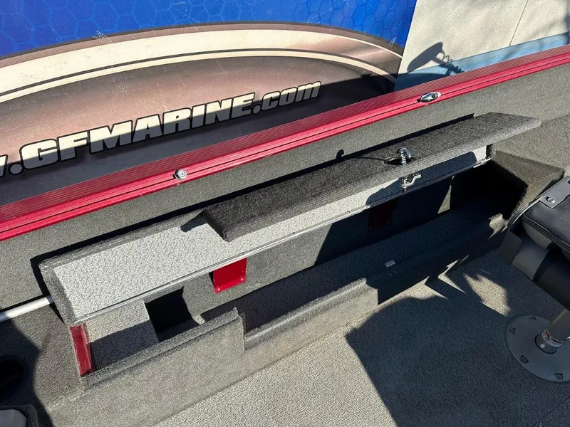 Slide: The Image of 2015 Lund 1750 Rebel XS SS boat storage compartment with open lid, showcasing interior space. - 32