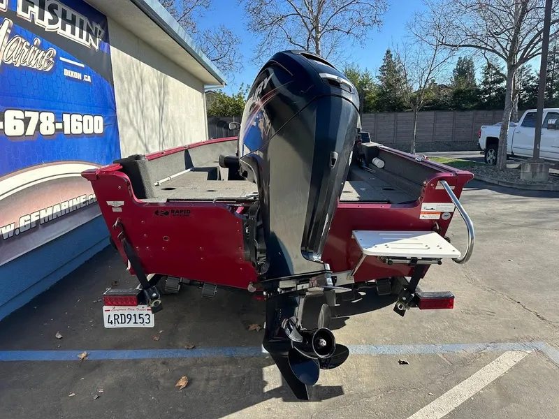 Slide: The Image of 2015 Lund 1750 Rebel XS SS boat with outboard motor in parking lot. - 9