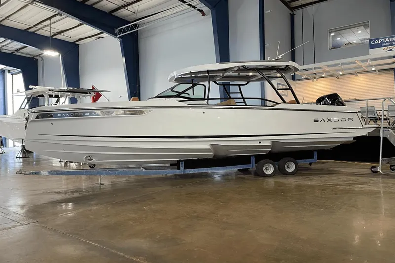 Slide: The Image of 2024 Saxdor 270 GTO boat displayed indoors on a trailer. - 0