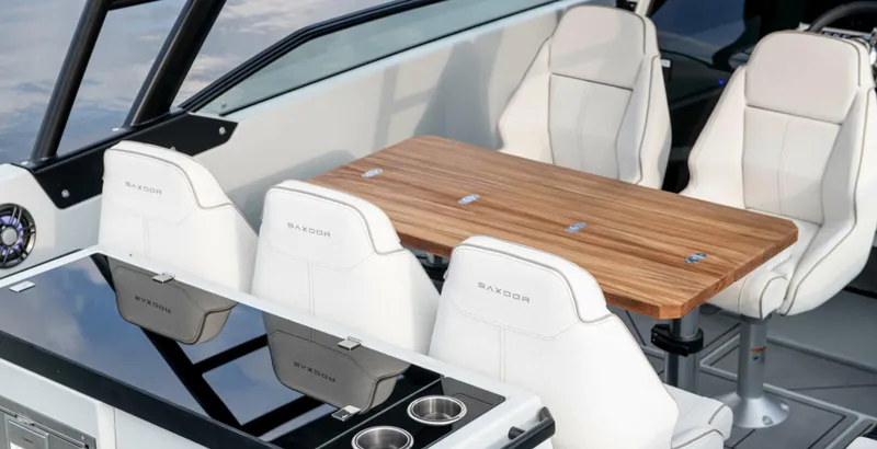 Slide: The Image of 2024 Saxdor 270 GTO interior with white seats and wooden table. - 6