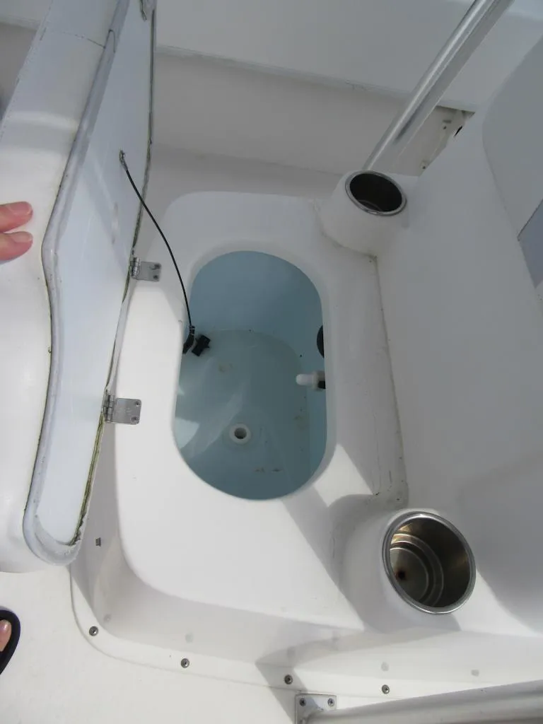 Slide: The Image of 2013 Sundance B20CCR boat livewell with open lid and cup holders. - 10
