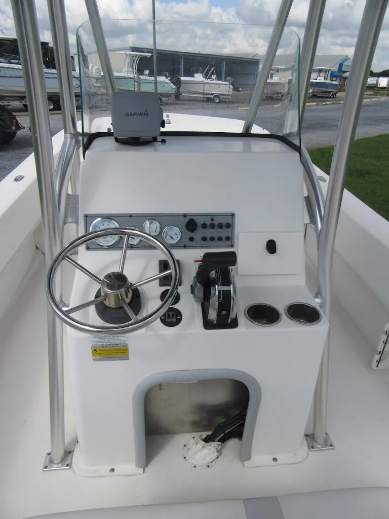 Slide: The Image of 2013 Sundance B20CCR boat console with steering wheel and controls. - 11