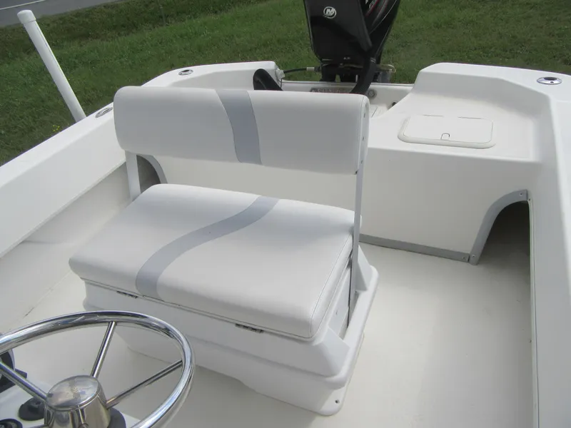 Slide: The Image of 2013 Sundance B20CCR boat interior with white seating and steering wheel. - 12