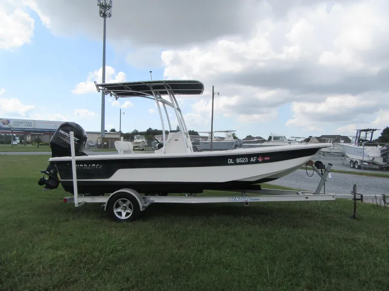 Slide: The Image of 2013 Sundance B20CCR boat on trailer, parked on grass under cloudy sky. - 3