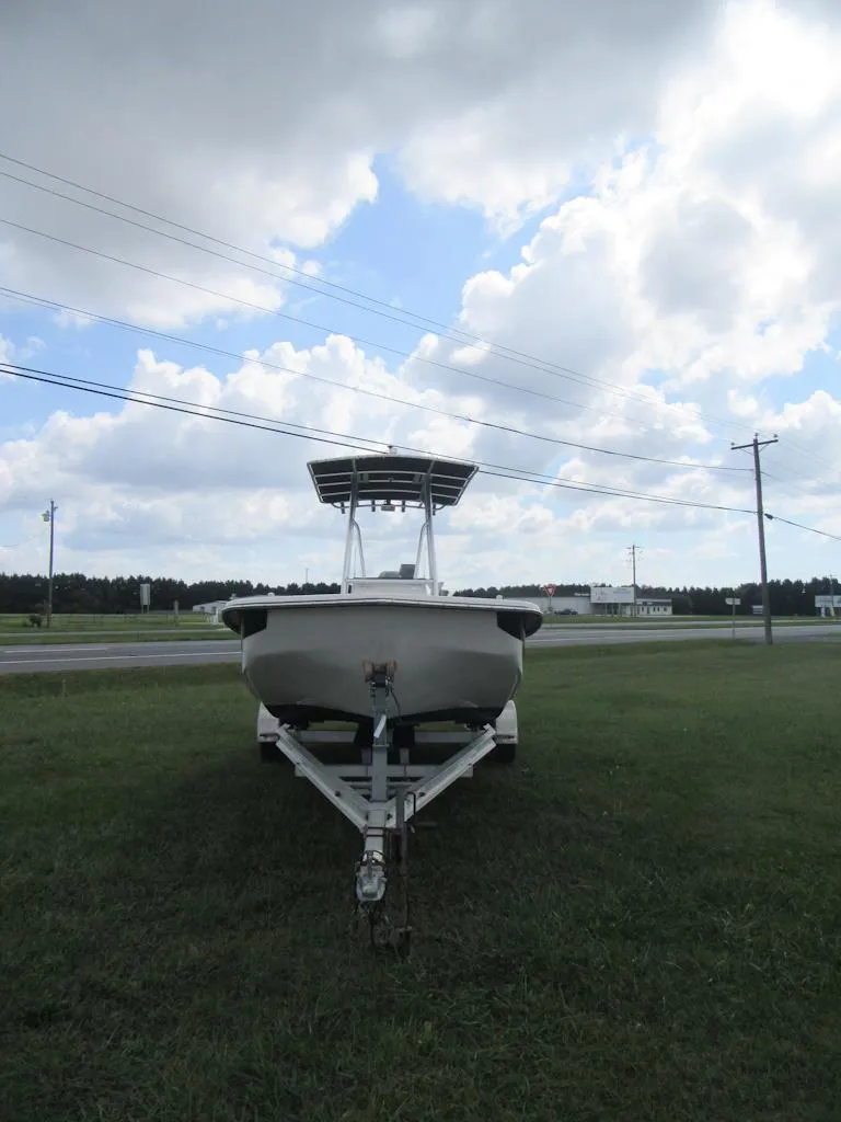 Slide: The Image of 2013 Sundance B20CCR boat on trailer under cloudy sky. - 4