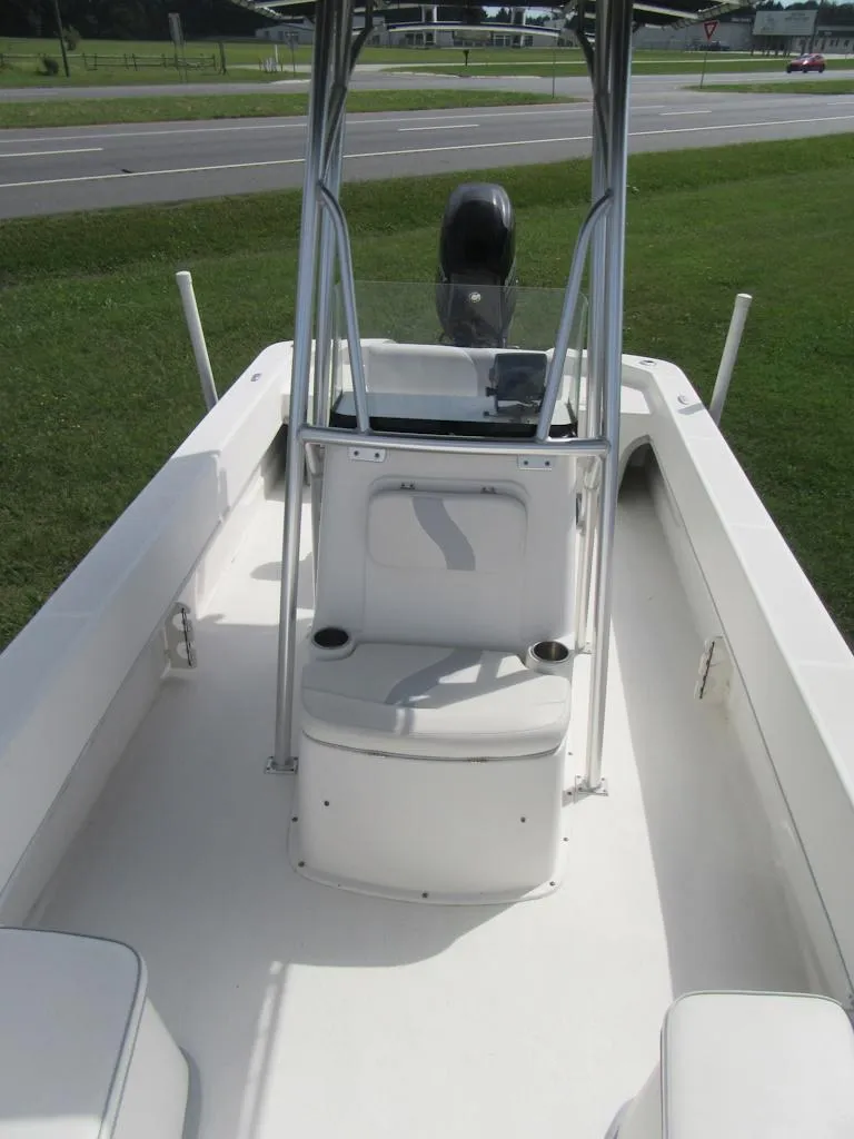 Slide: The Image of 2013 Sundance B20CCR boat with center console, white interior, and outdoor setting. - 7