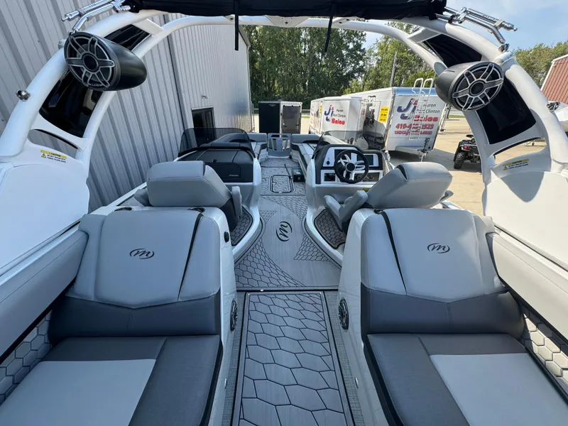 Slide: The Image of 2024 Manitou 27 XT RFXW boat interior with modern seating and sleek design. - 10