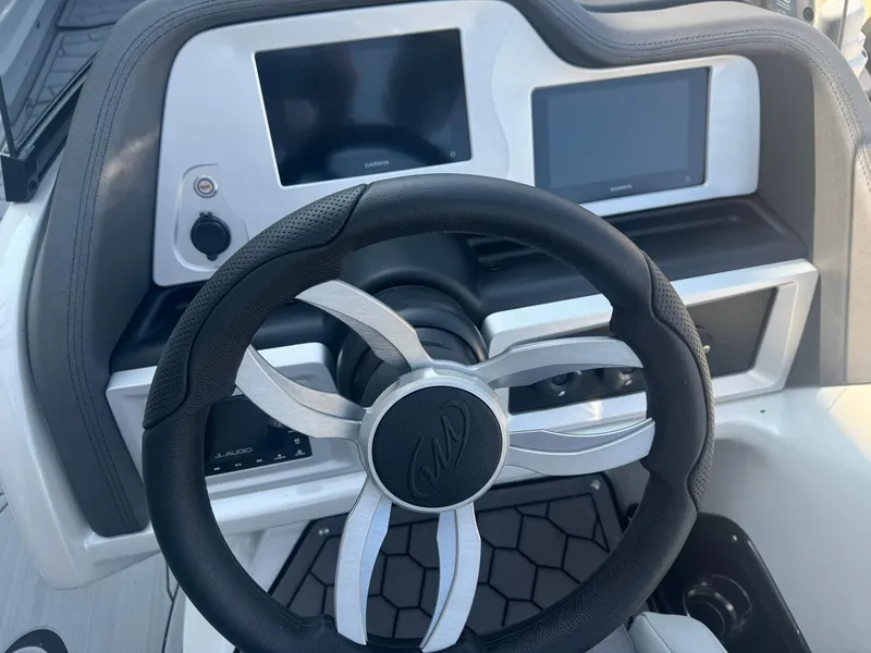 Slide: The Image of Steering wheel and dashboard of 2024 Manitou 27 XT RFXW boat. - 12