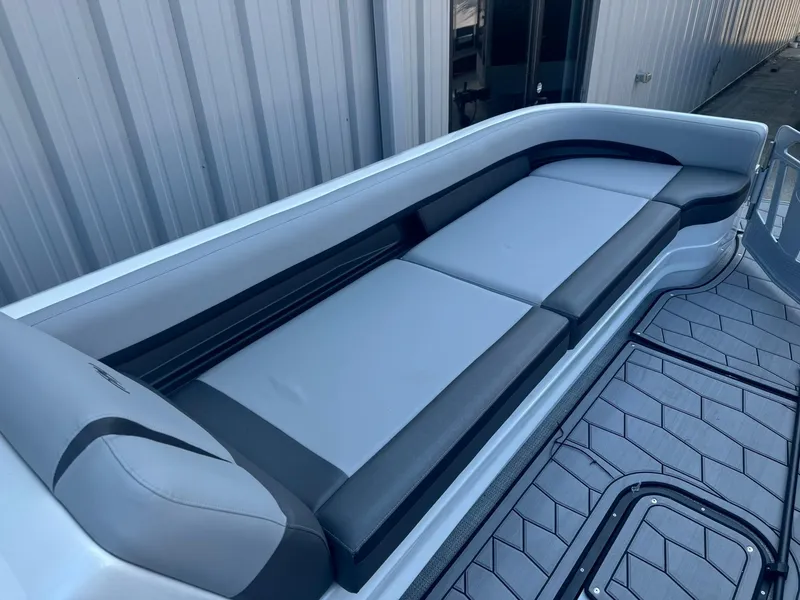 Slide: The Image of 2024 Manitou 27 XT RFXW boat seating with sleek gray upholstery and modern design. - 17