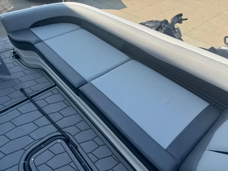 Slide: The Image of 2024 Manitou 27 XT RFXW boat interior with sleek seating and modern design. - 18