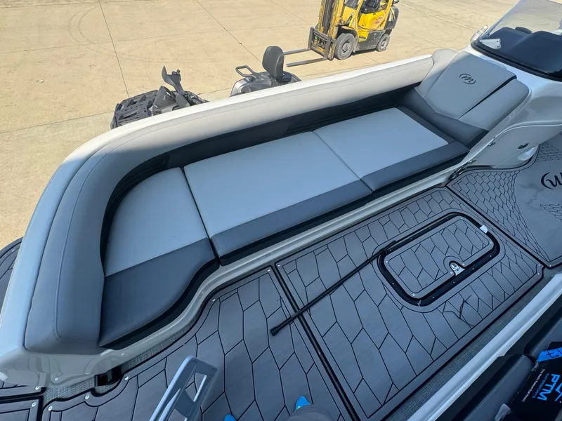 Slide: The Image of 2024 Manitou 27 XT RFXW boat interior with sleek seating and modern flooring design. - 19