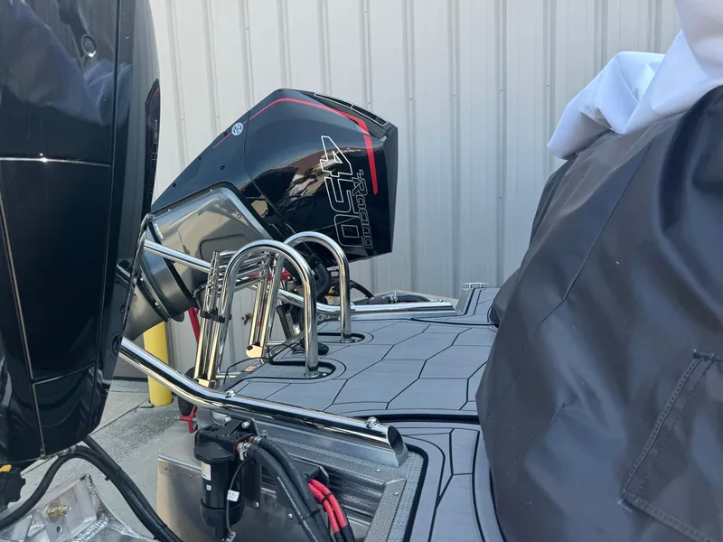 Slide: The Image of 2024 Manitou 27 XT RFXW boat with powerful outboard motor and sleek design. - 22