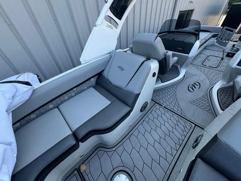 Slide: The Image of 2024 Manitou 27 XT RFXW boat interior with sleek seating and modern design. - 5