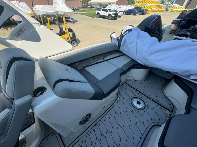 Slide: The Image of 2024 Manitou 27 XT RFXW boat interior with sleek seating and modern design. - 6