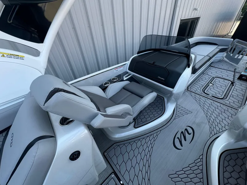 Slide: The Image of 2024 Manitou 27 XT RFXW boat interior with sleek seating and modern design. - 7