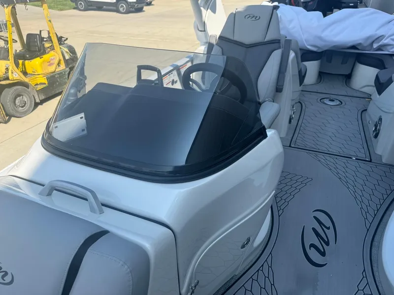 Slide: The Image of 2024 Manitou 27 XT RFXW boat interior with sleek design and modern dashboard. - 9