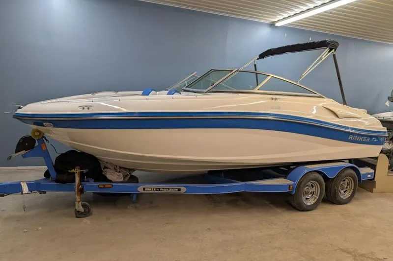Slide: The Image of 2012 Rinker Captiva 216 BR boat on trailer in indoor storage. - 0