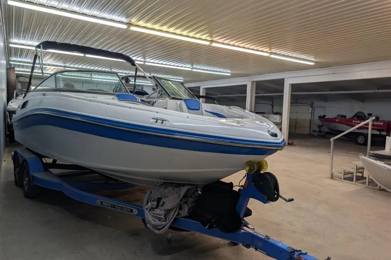 Slide: The Image of 2012 Rinker Captiva 216 BR boat on trailer in indoor storage facility. - 2