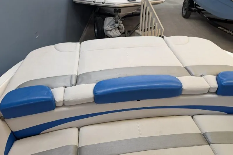 Slide: The Image of 2012 Rinker Captiva 216 BR boat interior with blue and white seating. - 3