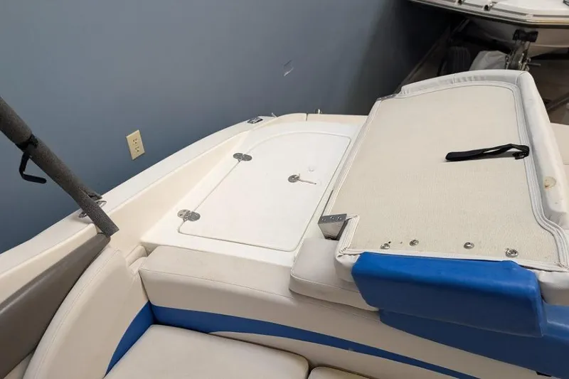 Slide: The Image of 2012 Rinker Captiva 216 BR boat interior with white and blue seating. - 4