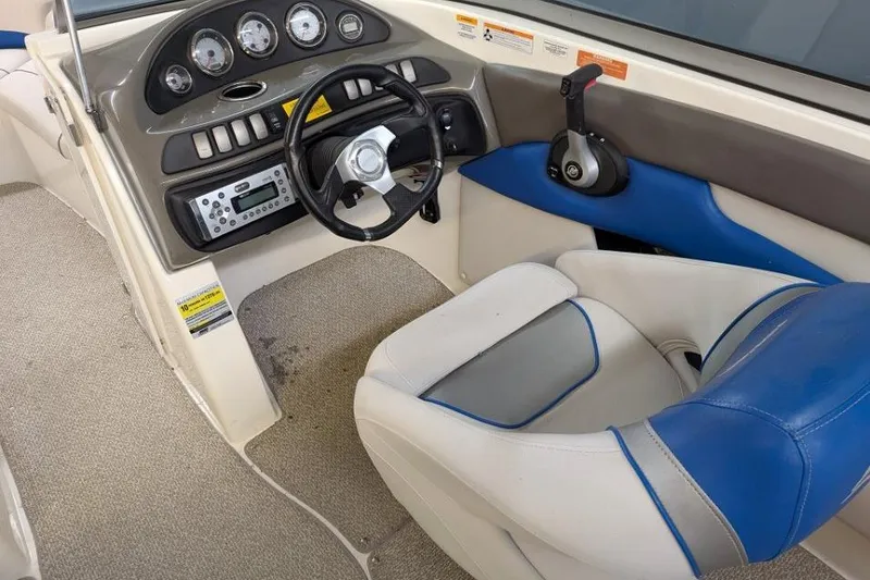 Slide: The Image of 2012 Rinker Captiva 216 BR boat interior with steering wheel and control panel. - 5