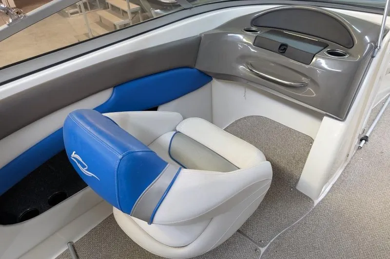 Slide: The Image of 2012 Rinker Captiva 216 BR boat interior with blue and gray seating. - 6