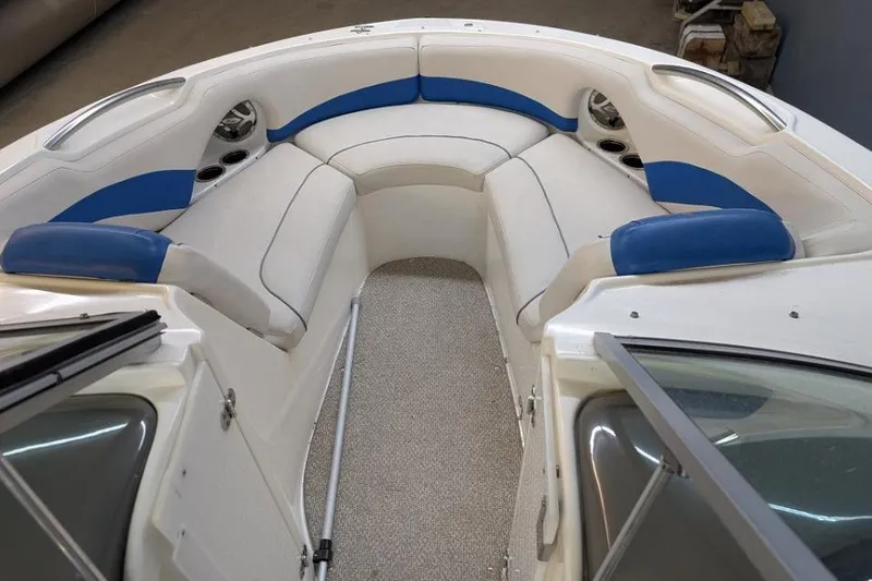 Slide: The Image of 2012 Rinker Captiva 216 BR boat interior with white and blue seating. - 7