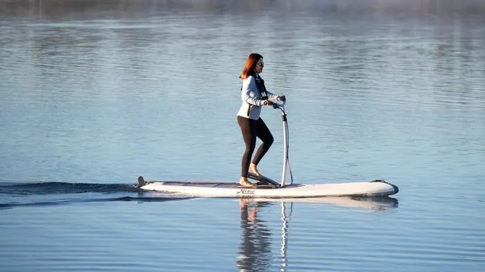 Slide: The Image of Woman riding 2025 Hobie Mirage Eclipse Ace on calm water. - 3