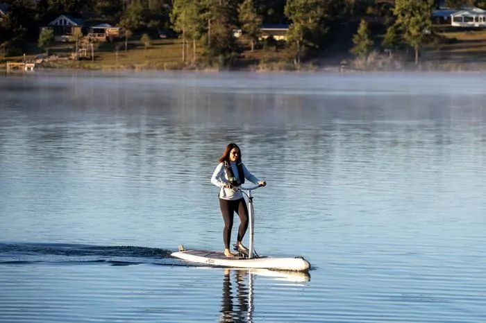 Slide: The Image of Person riding a 2025 Hobie Mirage Eclipse Ace on a calm lake. - 4