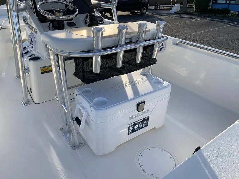 Slide: The Image of 2025 Bulls Bay 2200 XS boat interior with cooler and rod holders. - 11