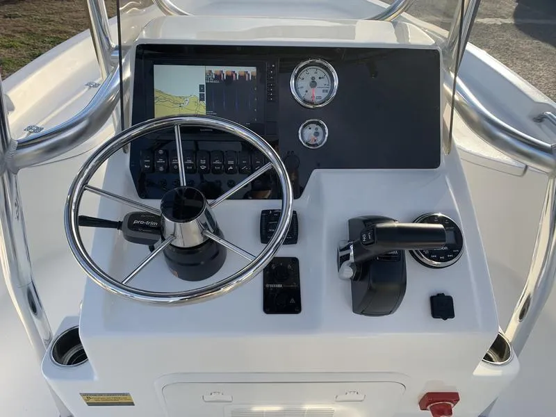 Slide: The Image of 2025 Bulls Bay 2200 XS boat console with steering wheel and controls. - 16
